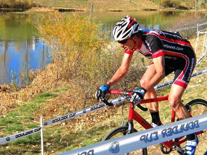 Cyclist riding a Zinn Cycles cyclocross bike on a track by a lake